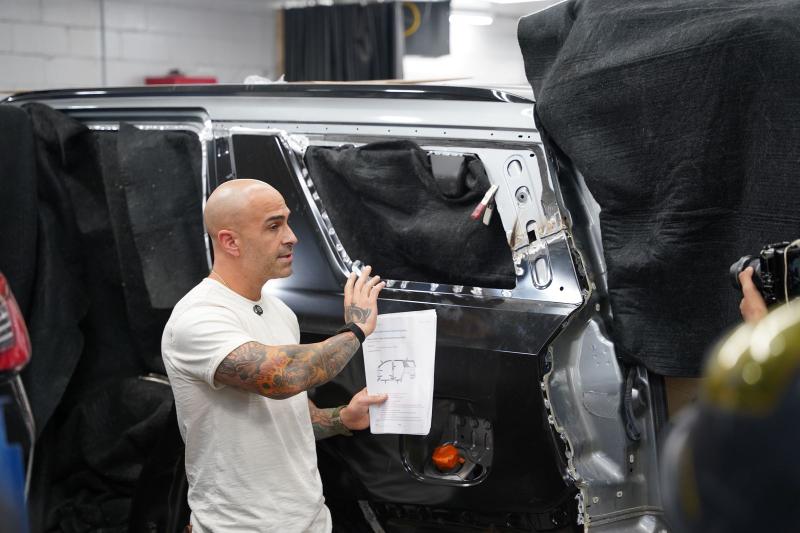 Metro Auto Body technician spray painting in the paint booth
