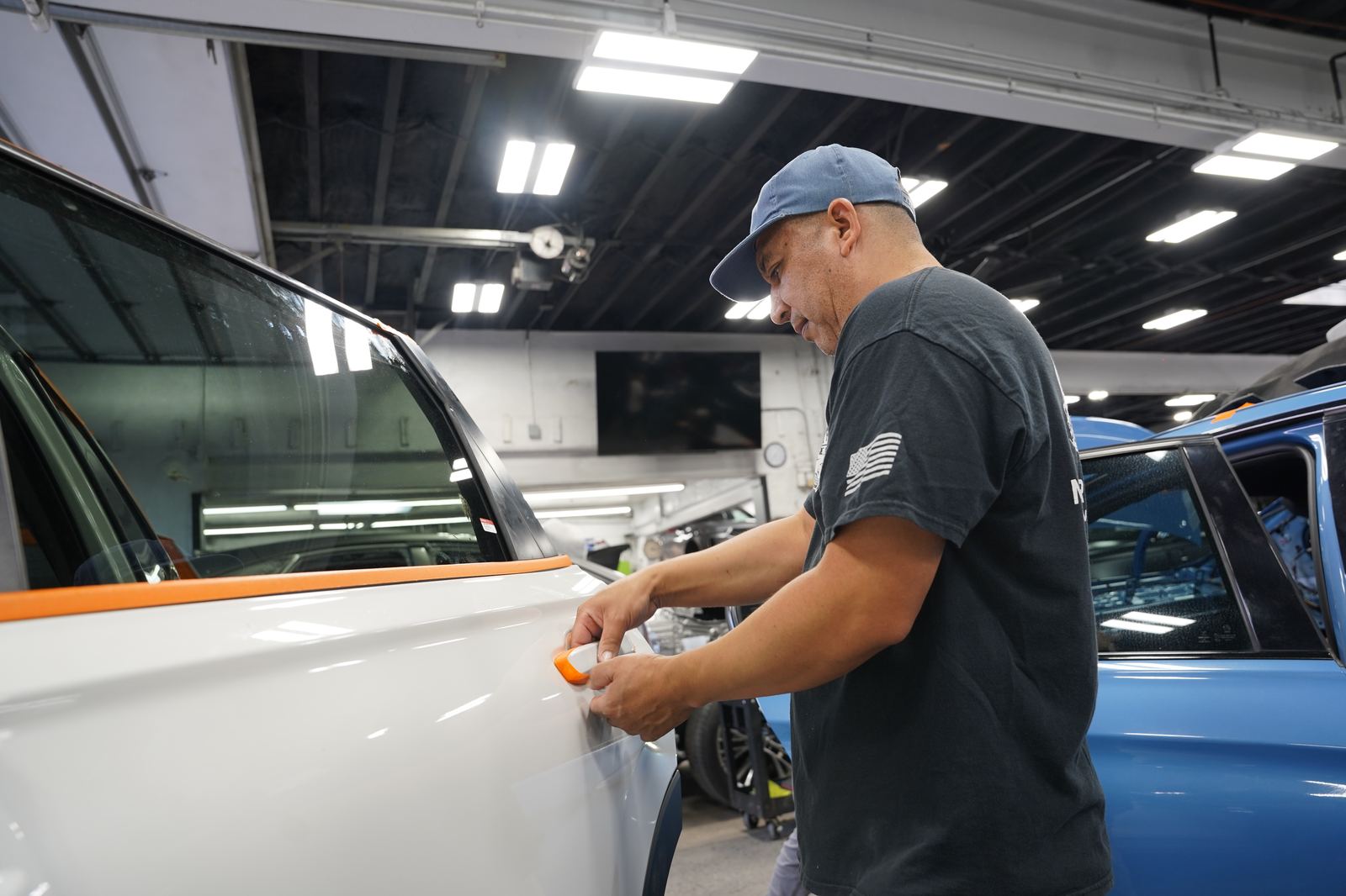 Metro Auto Body technician buffing a bumper during detailing