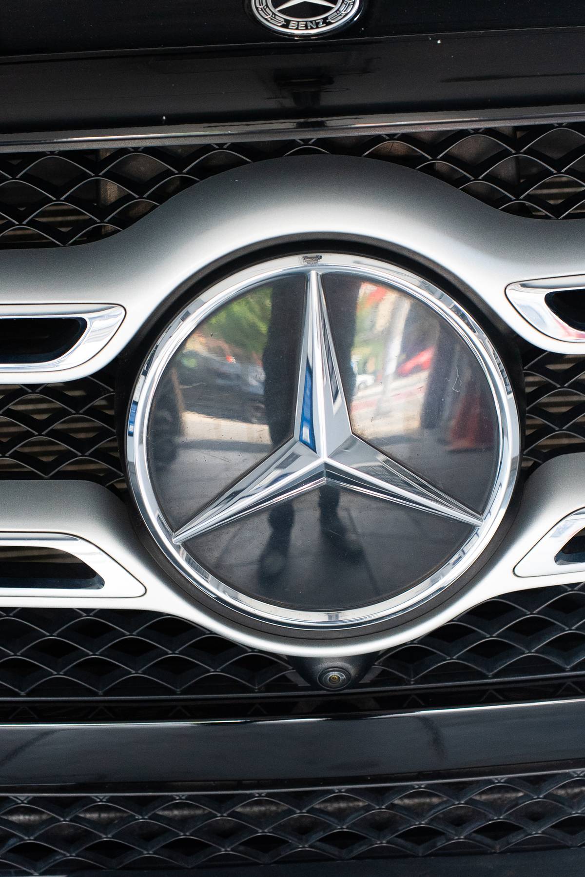 Close-up of a Mercedes-Benz grille badge on a vehicle in for certified collision repair