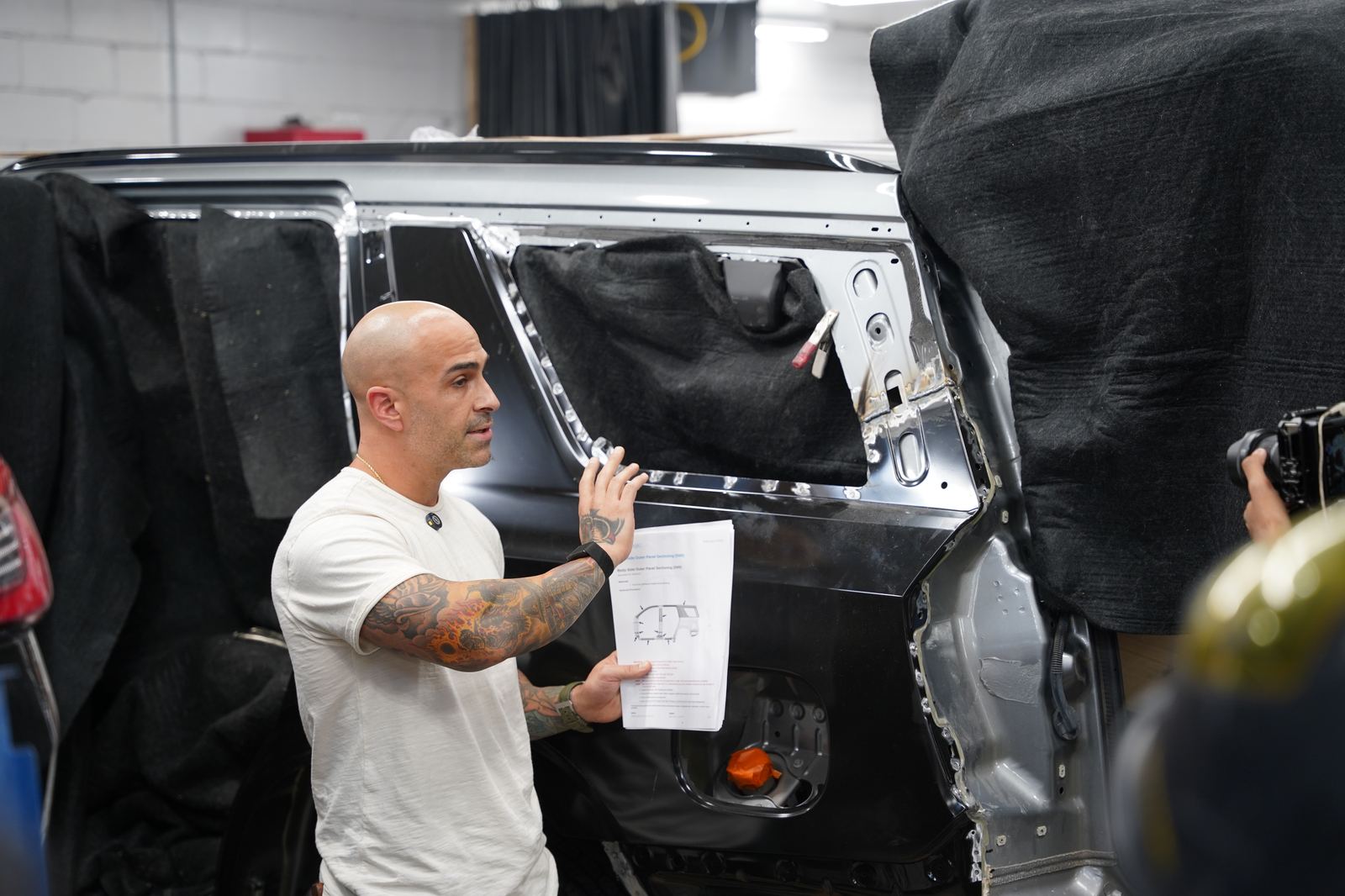 Metro Auto Body technician spray painting in the paint booth