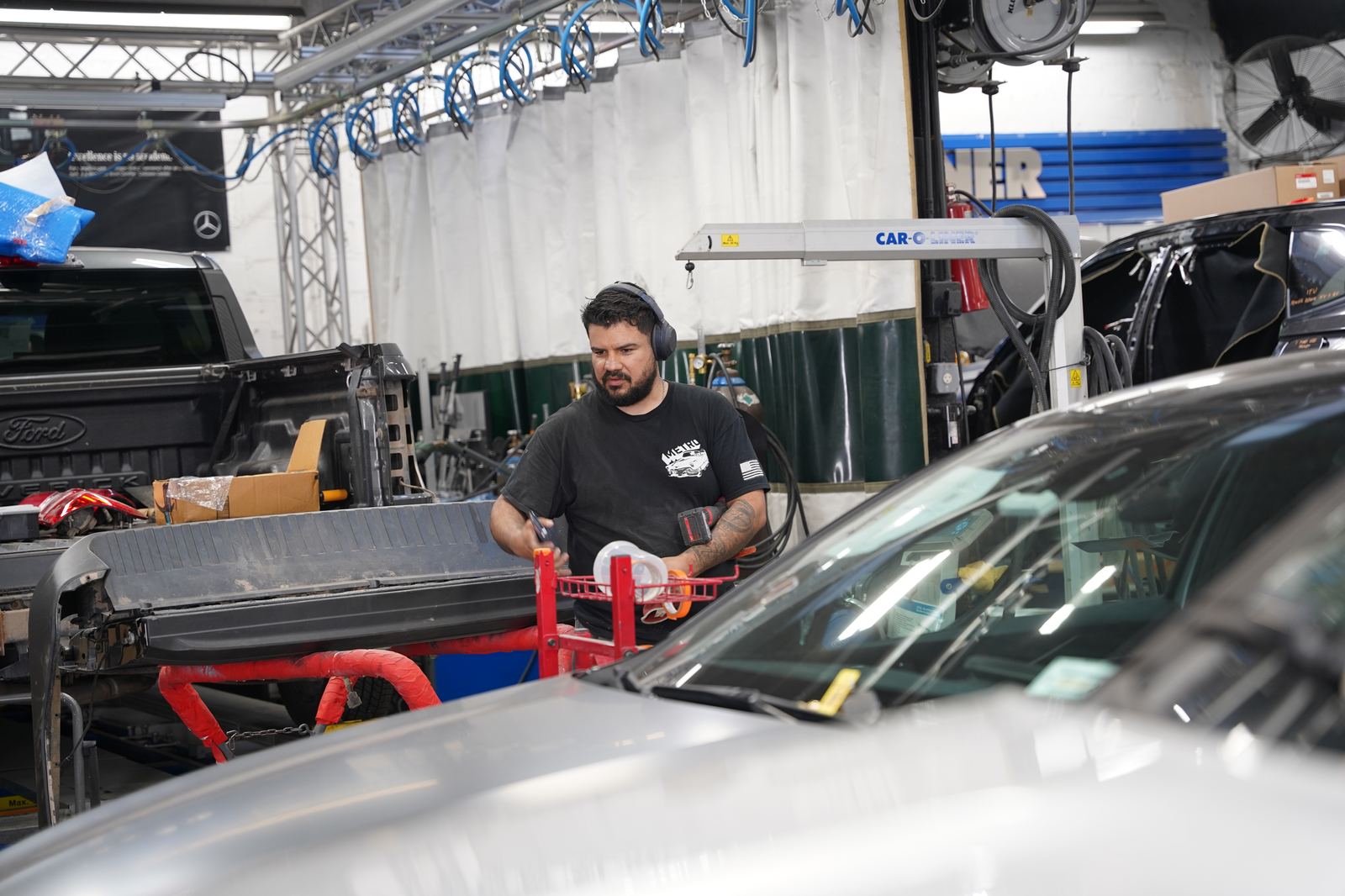 Metro Auto Body technician reviewing OEM repair procedures