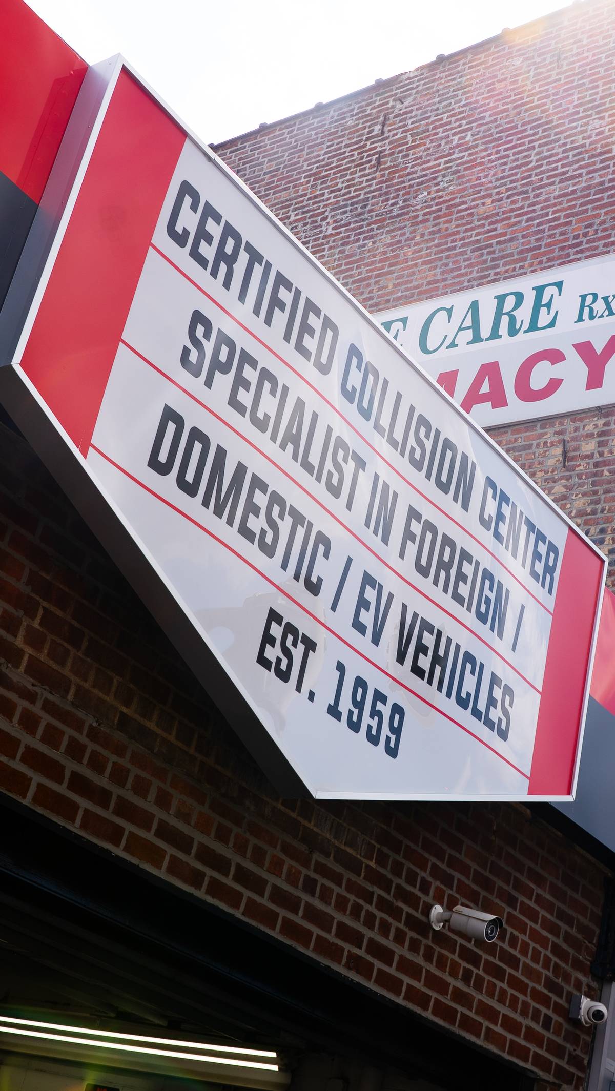 Certified collision center signage reading Est. 1959, specialists in foreign, domestic and EV vehicles